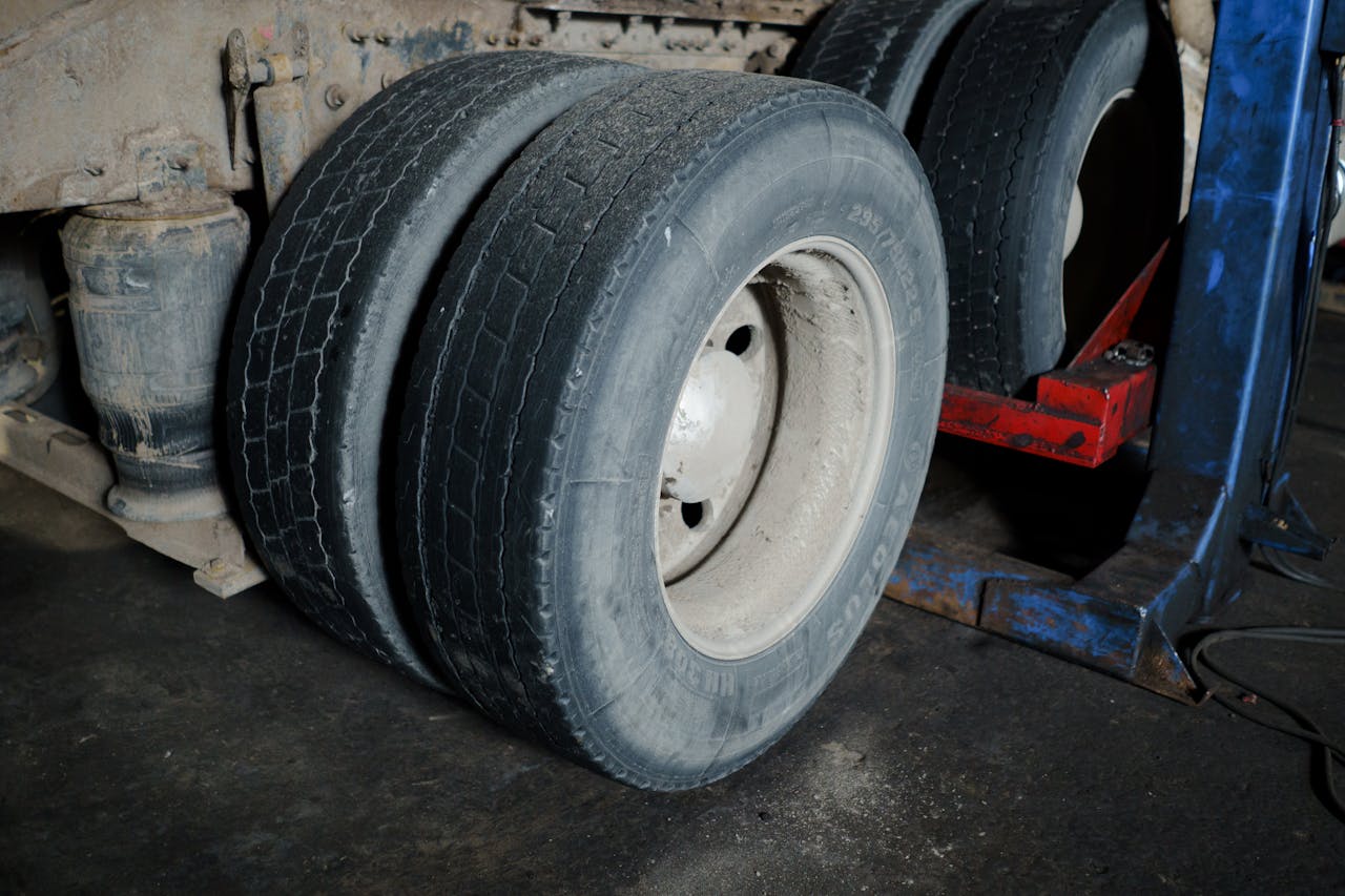 Mastering the First Impression: Your intriguing post title goes here Close-up of truck tires in a garage awaiting maintenance. Industrial setting with a focus on wheels.